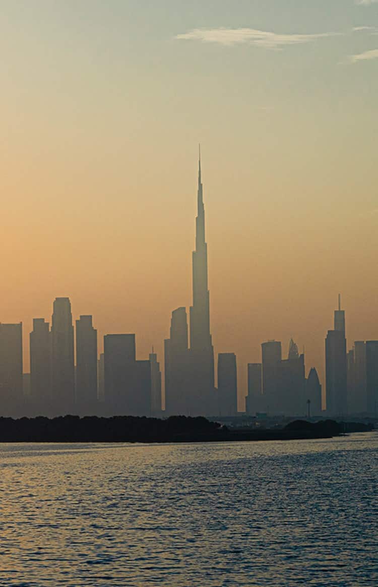 Dubai skyline at sunset with burj khalifa rising above the city