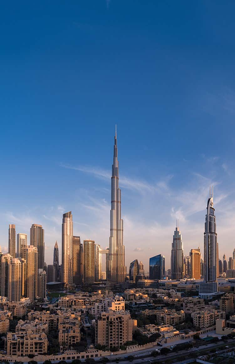 Dubai skyline at dusk with Burj Khalifa rising above the city skyline