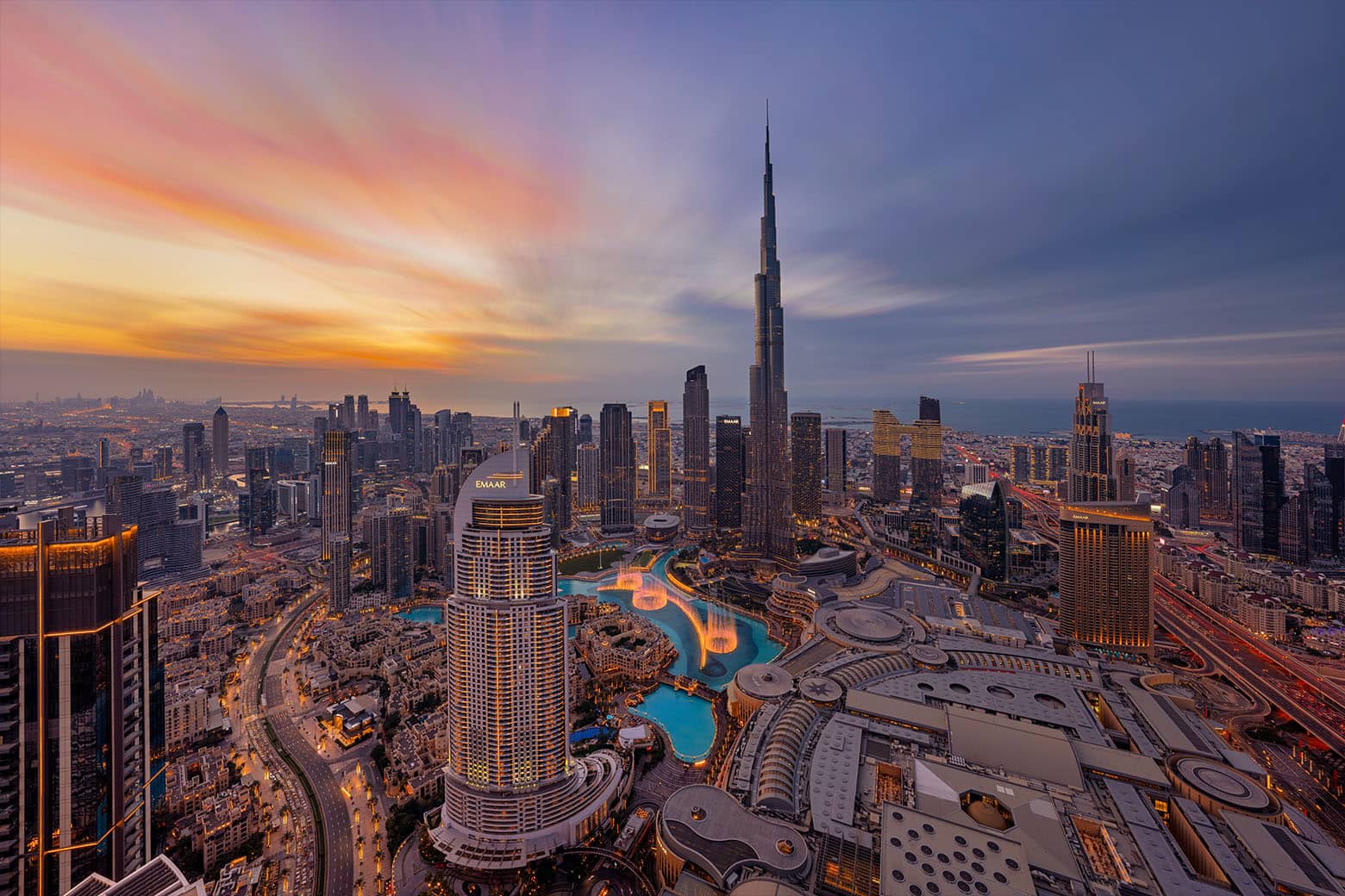 Stunning aerial sunset view of the Burj Khalifa and Downtown Dubai skyline.