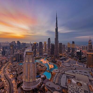 Stunning aerial sunset view of the Burj Khalifa and Downtown Dubai skyline.