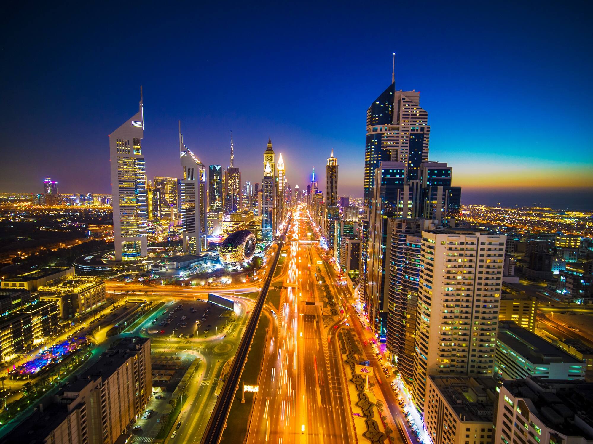 Dubai skyline and busy roads illuminated at night