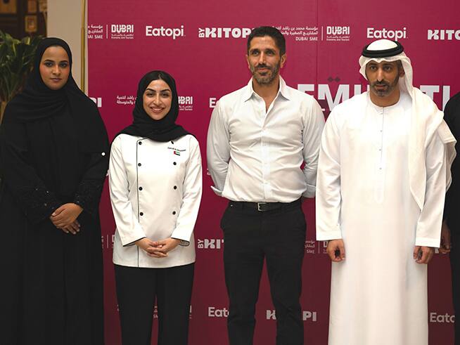 Four attendees pose for a group photo at the KITOPI Emirati Chefs Table Expansion event